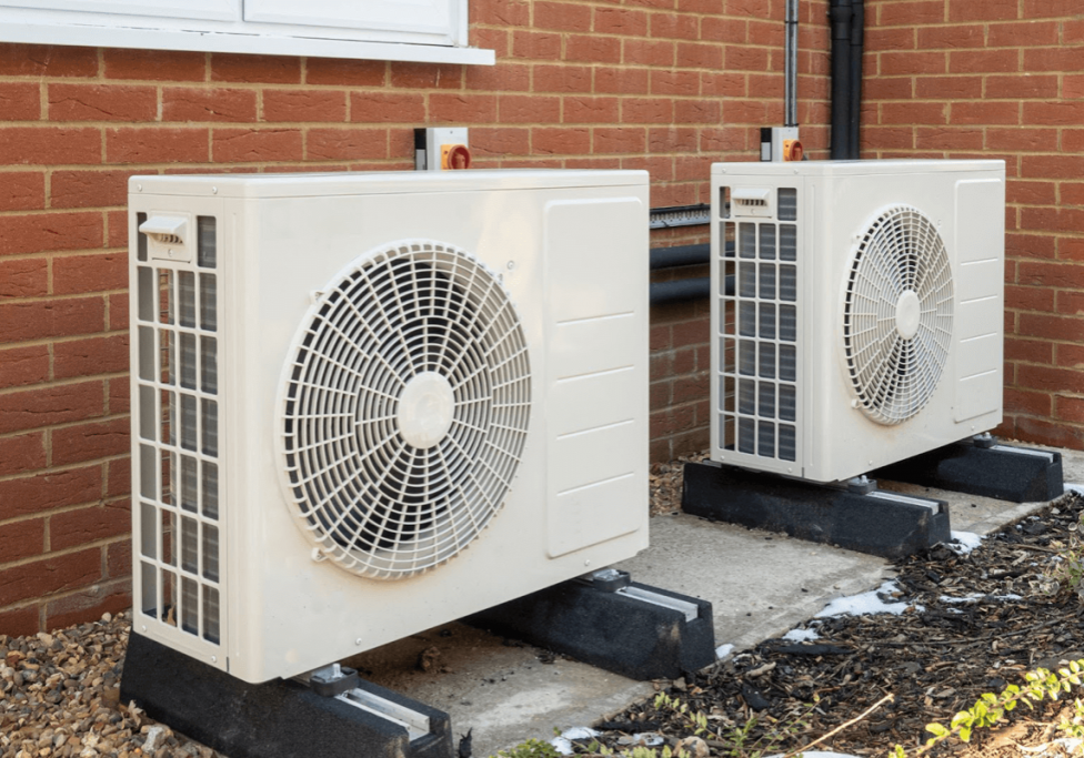 Two air source heat pumps outside a property